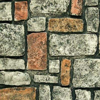 Tuscany faux stone panel with large round blocks in gray and terracotta, hand-painted chiseled texture and dark mortar joints for realistic wall finish