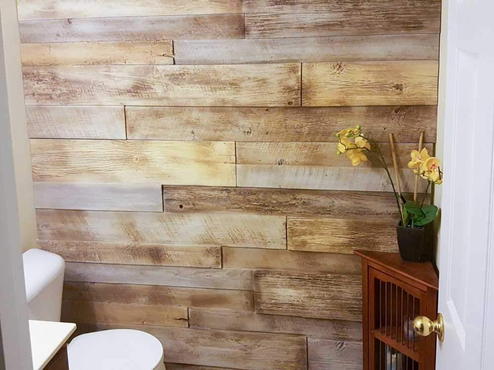 Bathroom accent wall in URESTONE reclaimed faux wood panels light brown planks, rustic texture.