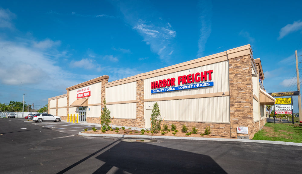 Harbor Freight store exterior with clear blue sky featuring stone accent corners, wainscot, and cornices.